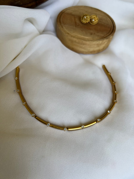 Kid friendly gold stiff necklace with small studs